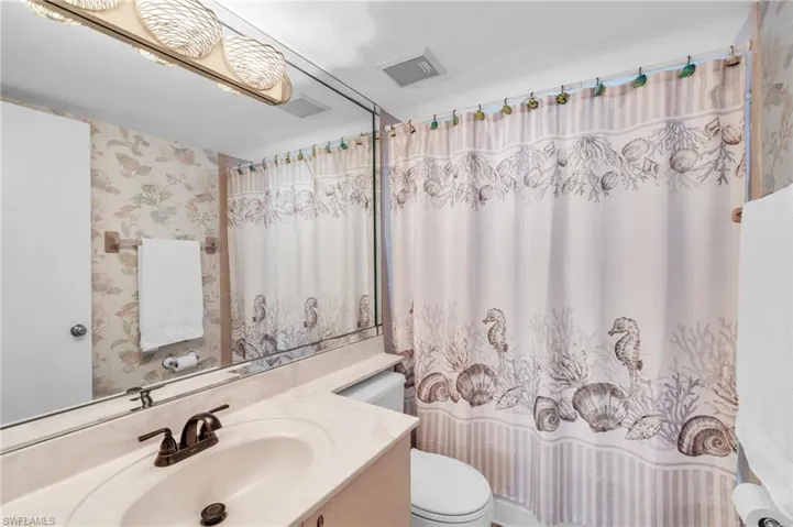 Bathroom with a shower, tub, vanity, and toilet