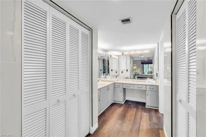 Bathroom with double vanity, walk in closet to the right, then shower/commode, linen closet on left