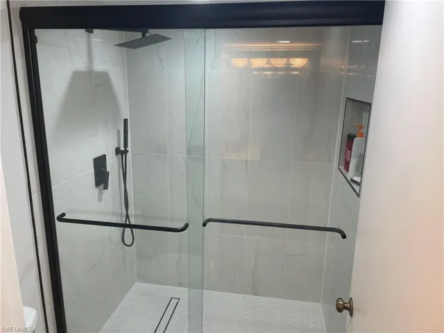 JUST UPDATED! Main Bathroom with brand new, tiled shower, sliding door, and accessories.