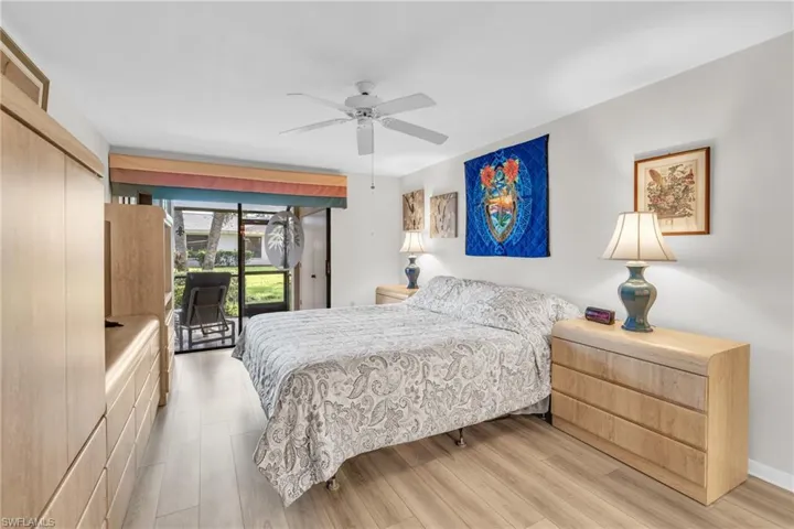 Bedroom suite with access to exterior lanai, ceiling fan, furniture