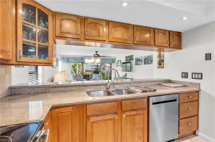 Kitchen with new stainless steel appliances  granite counters, ceiling fan, breakfast bar