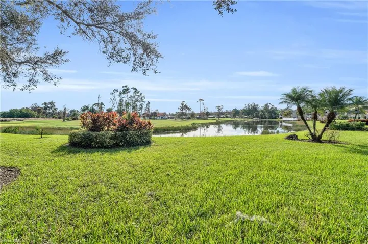 Yard with a golf course and water view