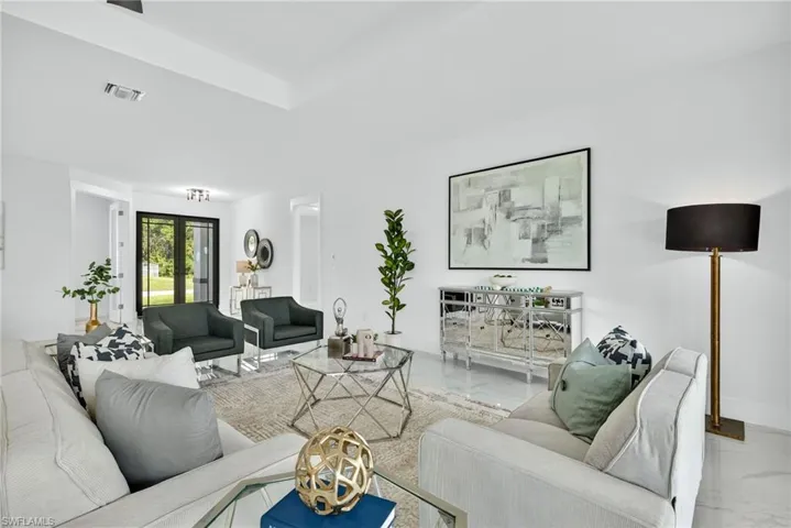 Living room with french doors and marble finish floors