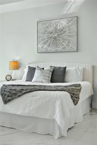 Bedroom with light marble finish floors
