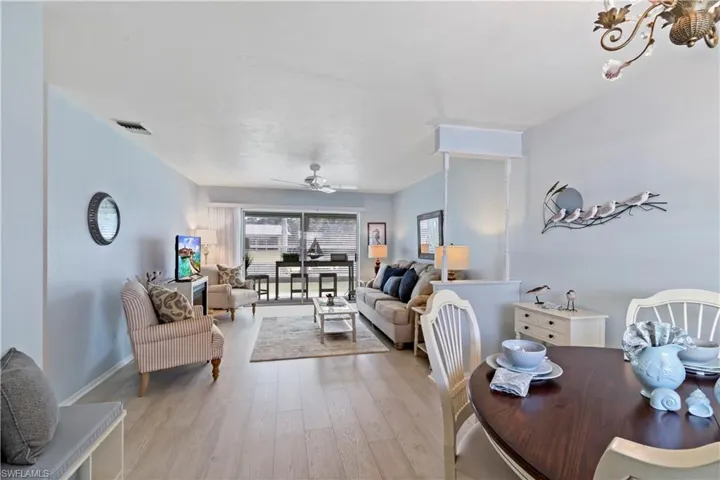 Living room with light wood-type flooring and ceiling fan