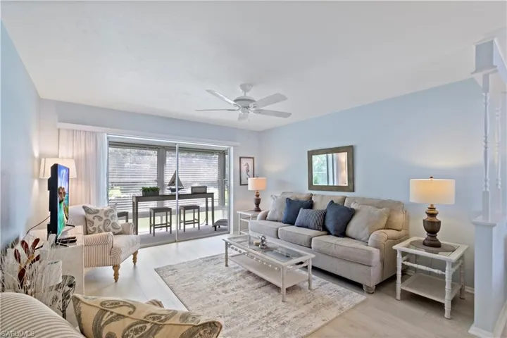 Living room featuring ceiling fan and light hardwood / wood-style flooring