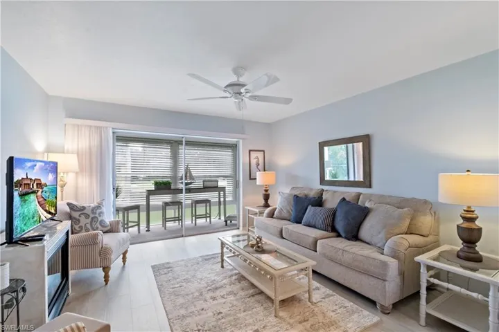 Living room featuring ceiling fan and light hardwood / wood-style floors