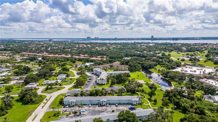 Birds eye view of property with a water view