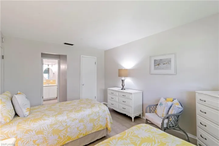 Bedroom featuring ensuite bathroom and light hardwood / wood-style flooring