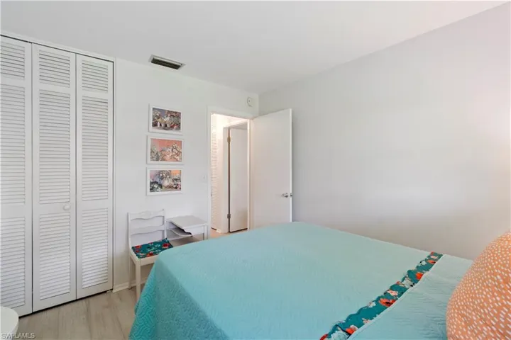 Bedroom with light hardwood / wood-style flooring and a closet