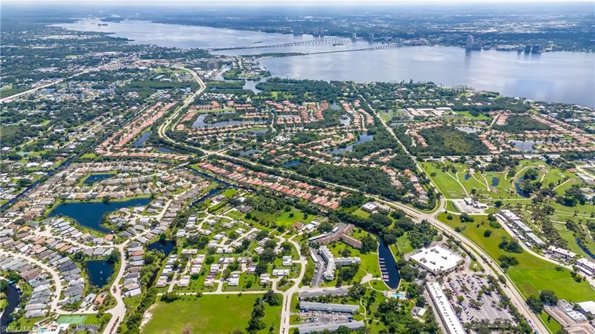 Birds eye view of property with a water view