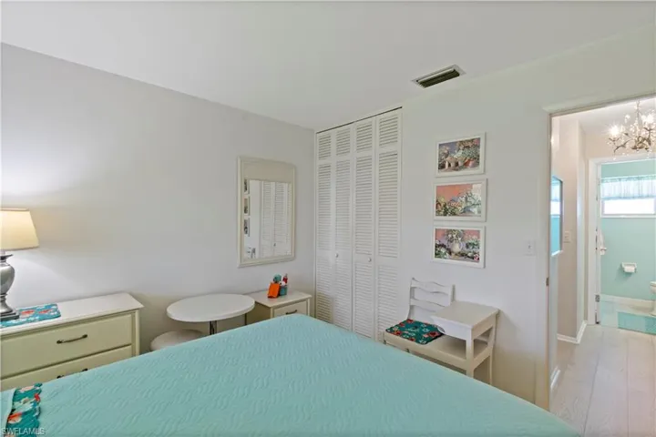 Bedroom featuring a closet, a notable chandelier, and light hardwood / wood-style floors