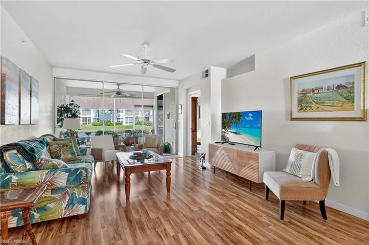 Living room featuring wood finished floors and ceiling fan