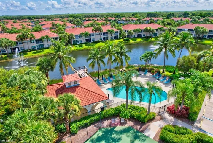 View of swimming pool with a water view and a patio