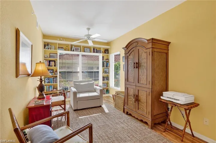 Living area with wood finished floors and ceiling fan