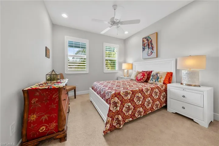 Bedroom featuring light gray walls, recessed lighting, and a white ceiling fan