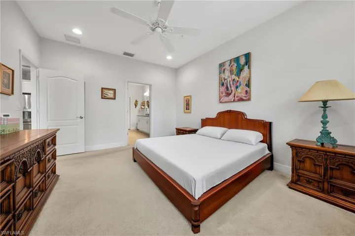 Carpeted bedroom with recessed lighting and a ceiling fan
