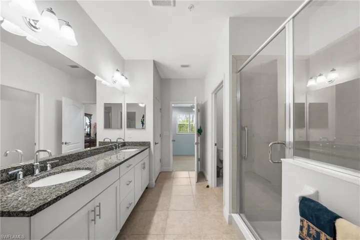 Dual vanity with granite-finish countertop, undermount sinks, and chrome fixtures