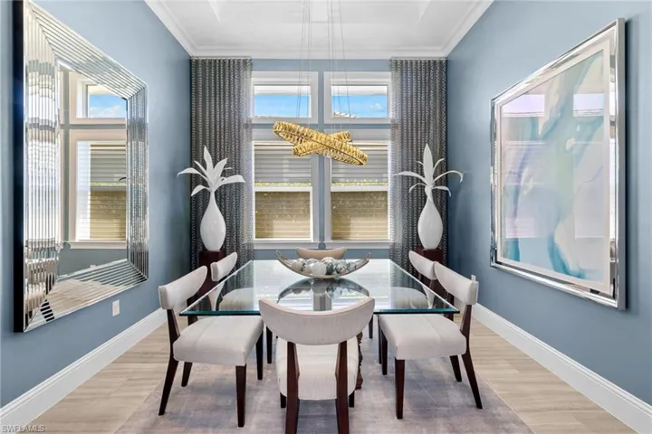 Formal dining space featuring light wood-finish flooring