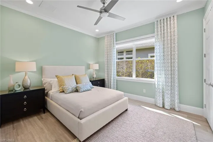 Bedroom #2, light-filled interior featuring wood-finish flooring, a ceiling fan, recessed lighting, and a window with blinds and patterned drapes