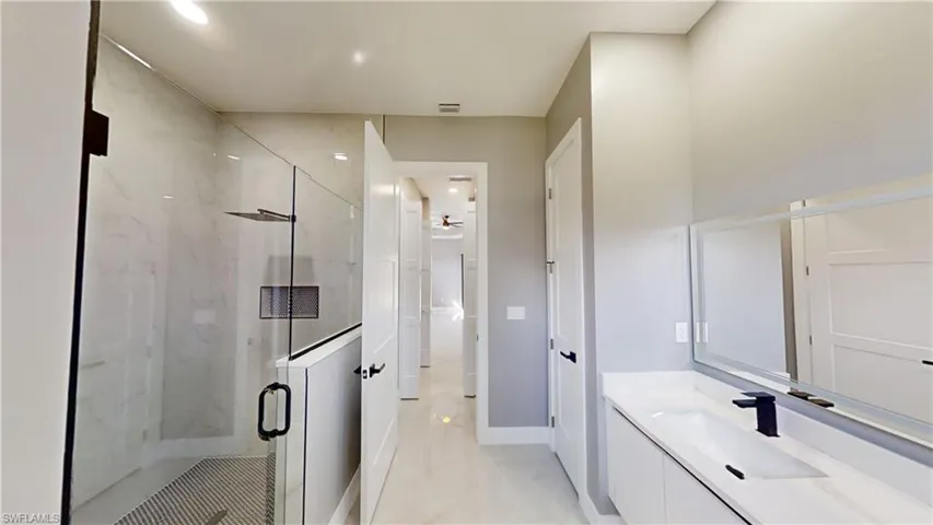 Bathroom with vanity and an enclosed shower