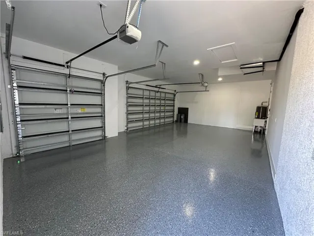 Garage featuring a garage door opener