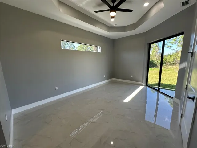 Spare room with ceiling fan and a raised ceiling