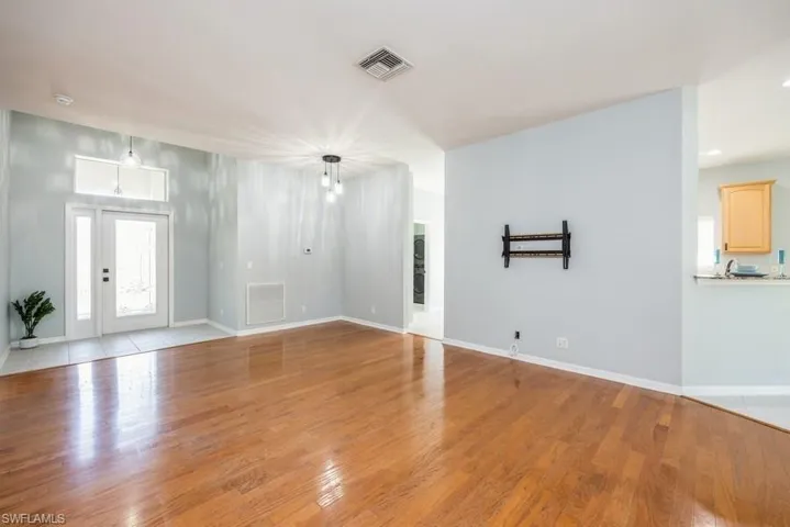 Unfurnished living room featuring a wealth of natural light and light wood-type flooring