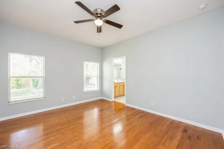 Empty room with ceiling fan and light hardwood / wood-style flooring