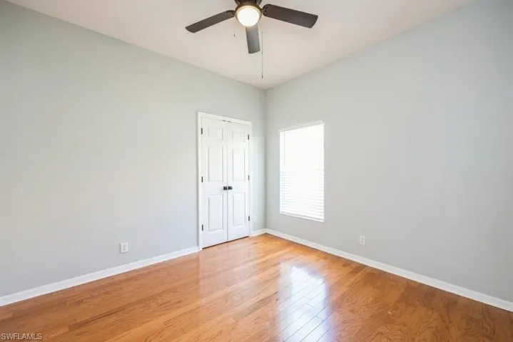 Empty room featuring ceiling fan and light hardwood / wood-style flooring