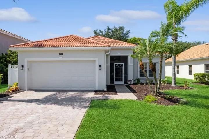 Mediterranean / spanish-style house with a front lawn and a garage