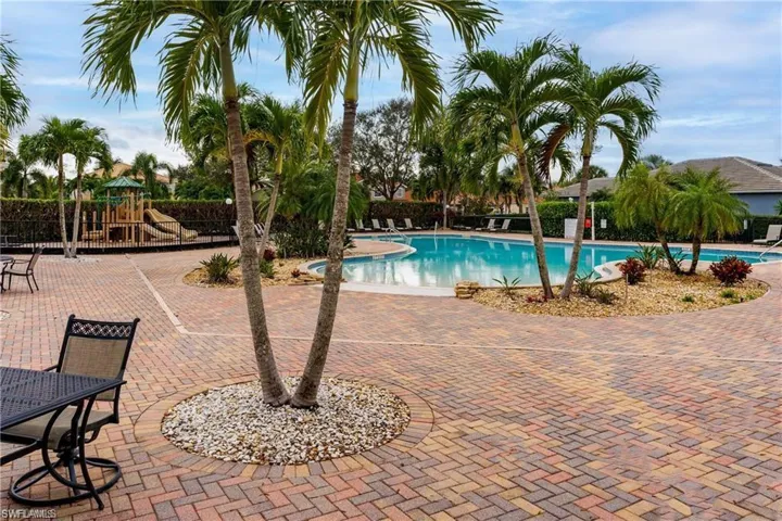 View of pool with a playground and a patio area