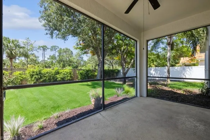 Unfurnished sunroom with ceiling fan