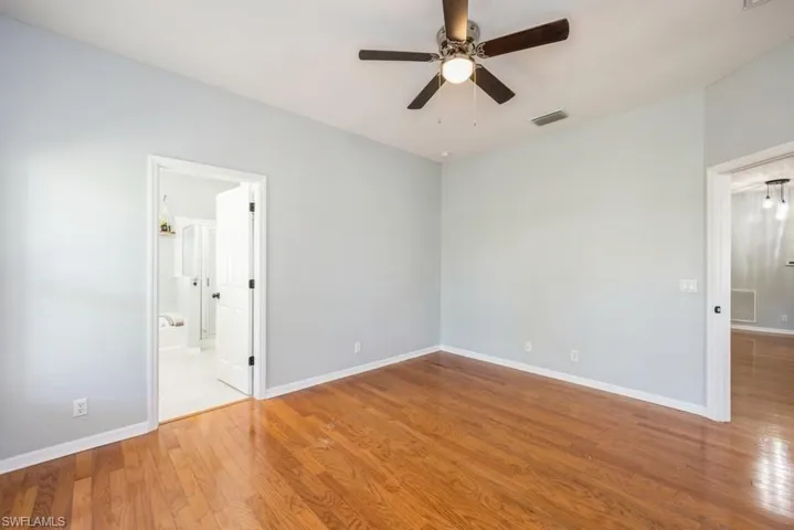 Tiled empty room with ceiling fan