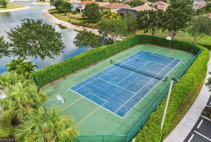 View of sport court featuring a water view