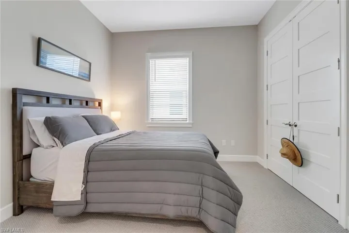 Carpeted bedroom featuring baseboards
