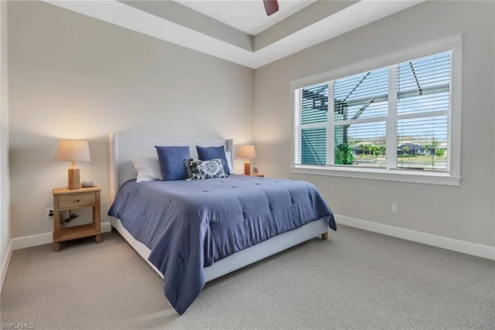Bedroom featuring ceiling fan, carpet floors, and baseboards