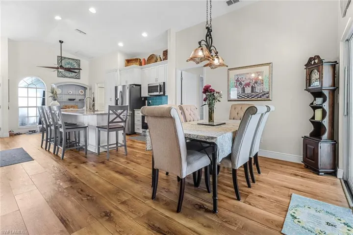 Dining area featuring high vaulted ceiling