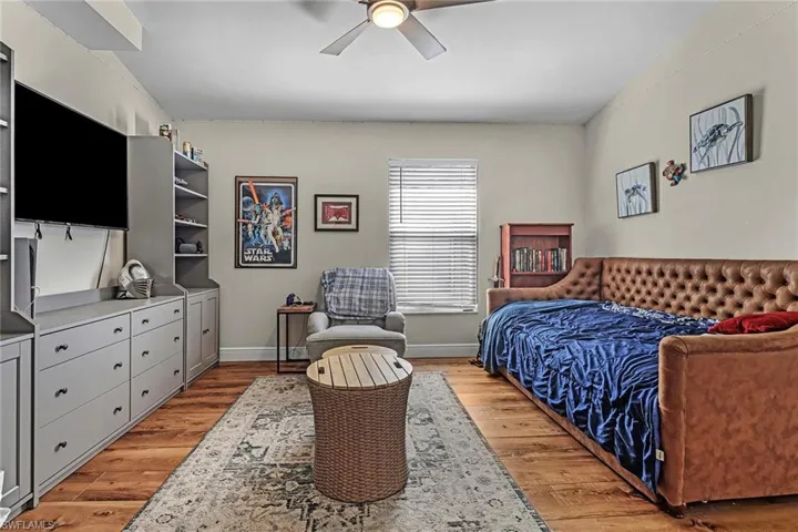 Bedroom with ceiling fan and light hardwood / wood-style flooring