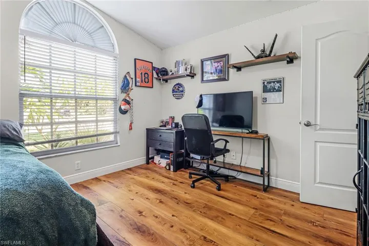 Home office featuring wood-type flooring and lofted ceiling