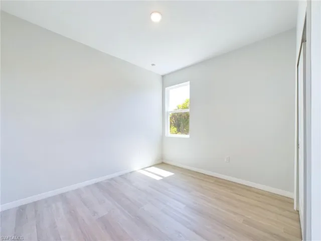 Unfurnished room with light hardwood / wood-style flooring