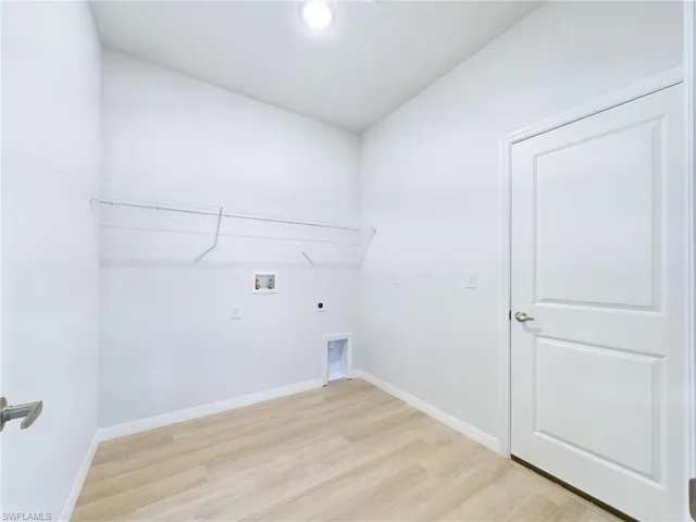 Laundry room featuring light wood-type flooring, washer hookup, and electric dryer hookup