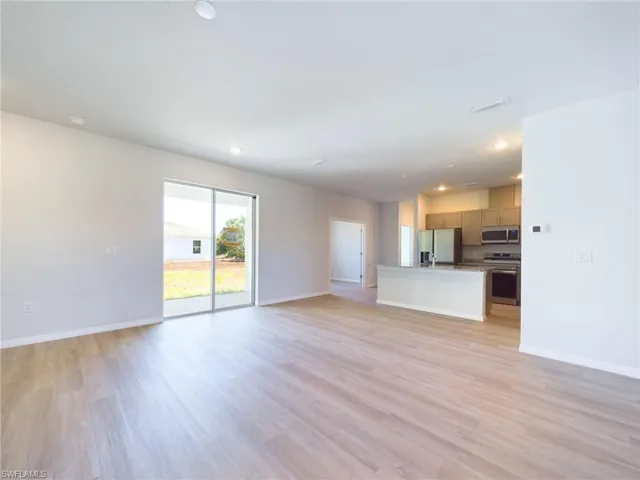 Unfurnished living room featuring light wood-type flooring