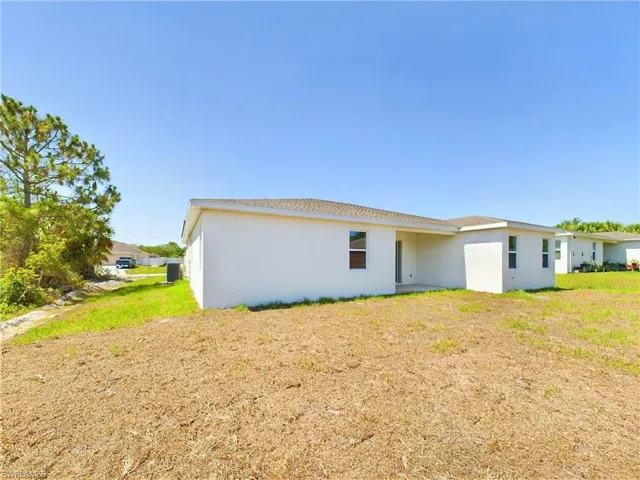 Back of house featuring a lawn