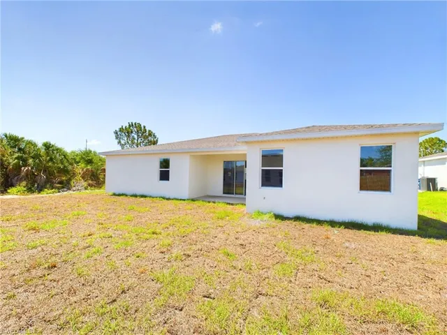 Back of house featuring a lawn