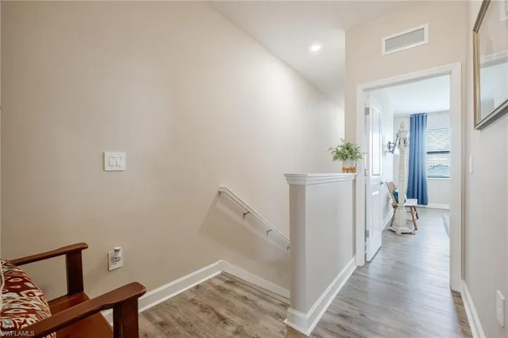 Hallway with light hardwood / wood-style flooring