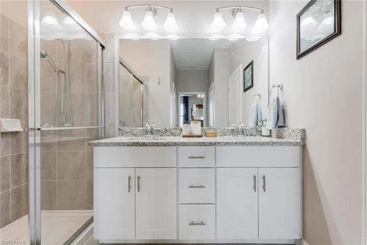 Bathroom featuring vanity and a shower with shower door