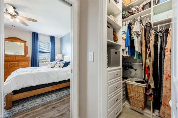 Bedroom featuring light hardwood / wood-style floors, ceiling fan, and a closet