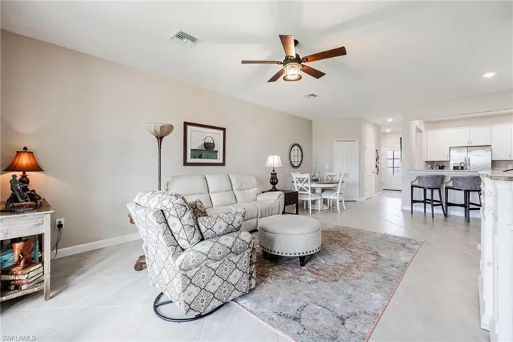 Living room featuring ceiling fan and light tile patterned floors