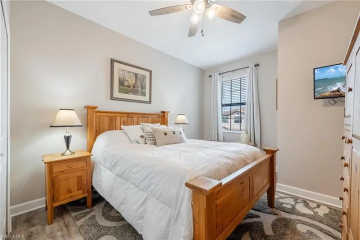 Bedroom with dark hardwood / wood-style flooring and ceiling fan